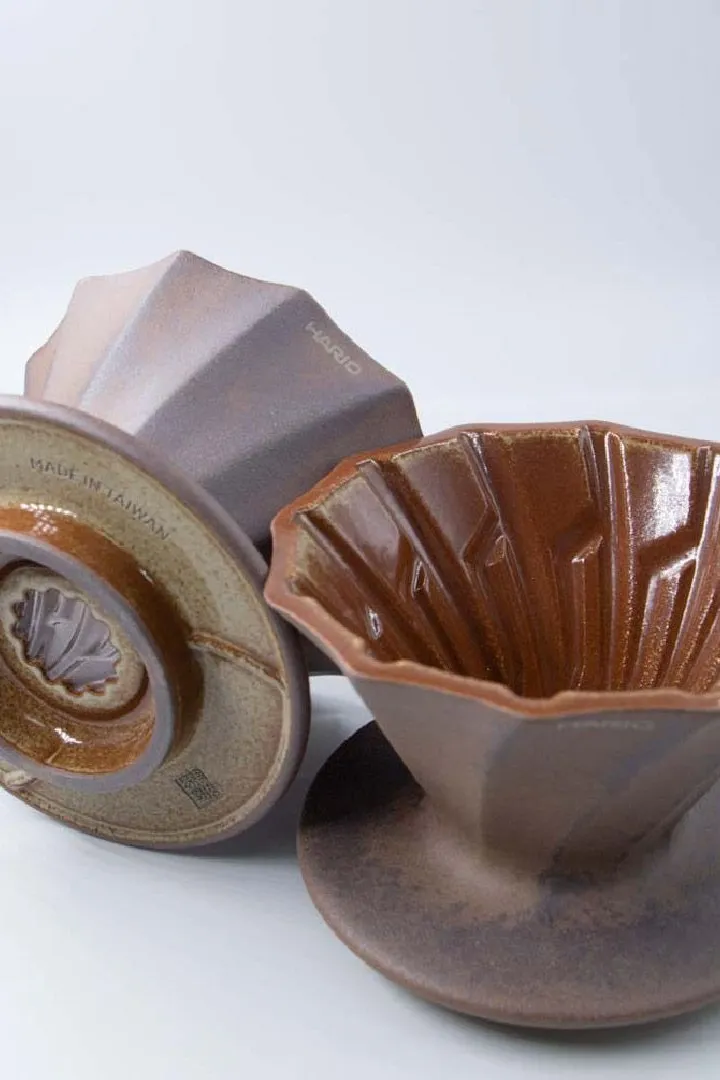 Two Alpha Lao Yan Ni drippers, one showing the glossy grooved inside and one the glazed base