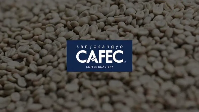 Navy Cafec Coffee Roastery logo, with the Sanyo Sangyo name above it, over green coffee beans