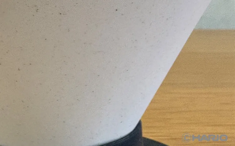 Close-up of the matte, lightly speckled unglazed surface of the white V60 NEO Ceramic